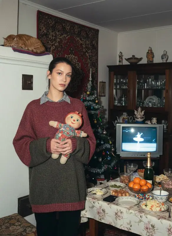 Young woman holding vintage doll in cozy nostalgic holiday room