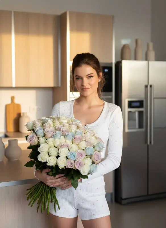 Beautiful Woman Holding Massive Pastel Rose Bouquet in Sunlit Kitchen