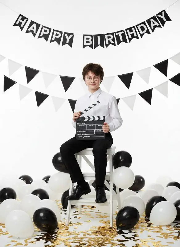 Young Boy Celebrating Movie Themed Birthday Party With Clapperboard