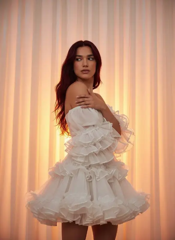 Elegant Woman in White Ruffled Dress with Warm Golden Lighting