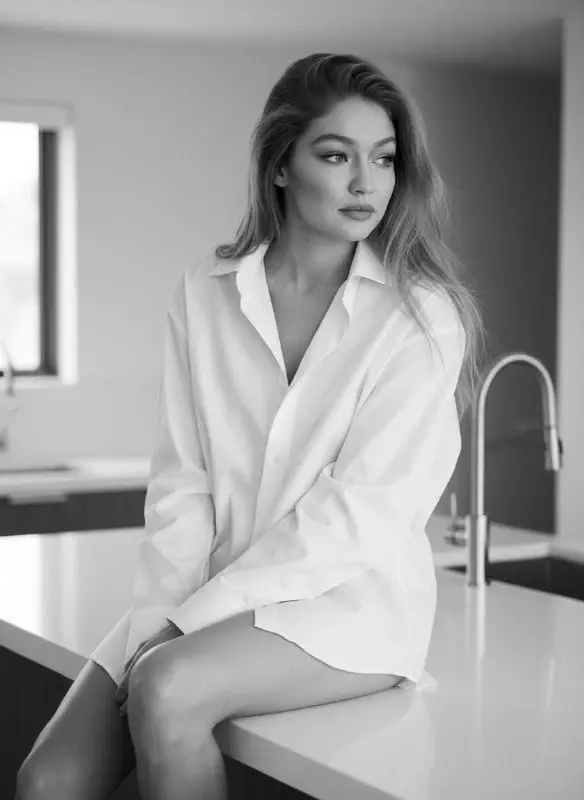 Black and white portrait of woman in oversized white shirt