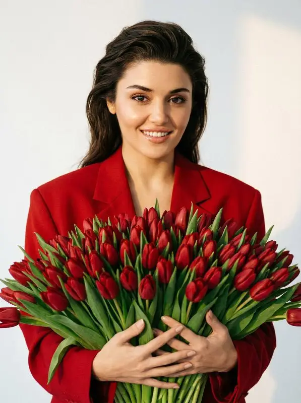 Elegant woman in red blazer holding huge tulip bouquet