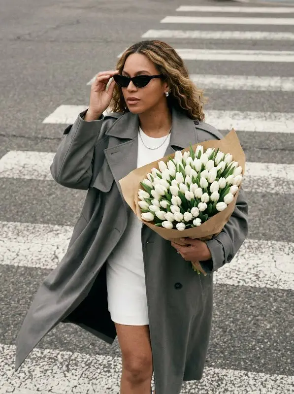 Stylish Woman in Grey Trench Coat Holding White Tulip Bouquet