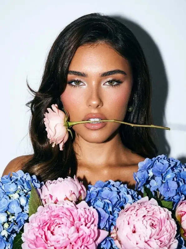 Elegant Young Woman with Pink Rose and Colorful Floral Bouquet