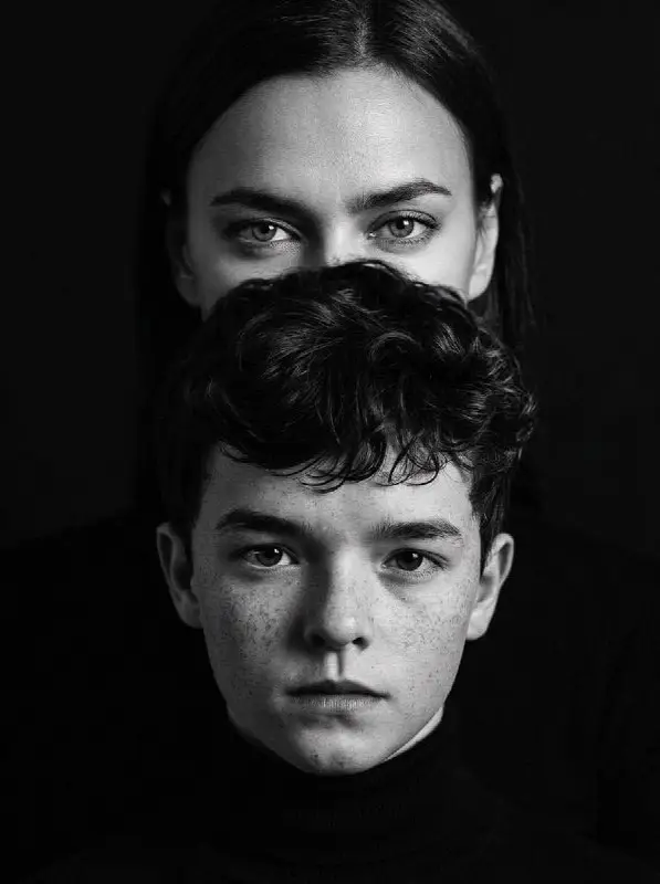 Intense black and white artistic portrait of a boy and woman