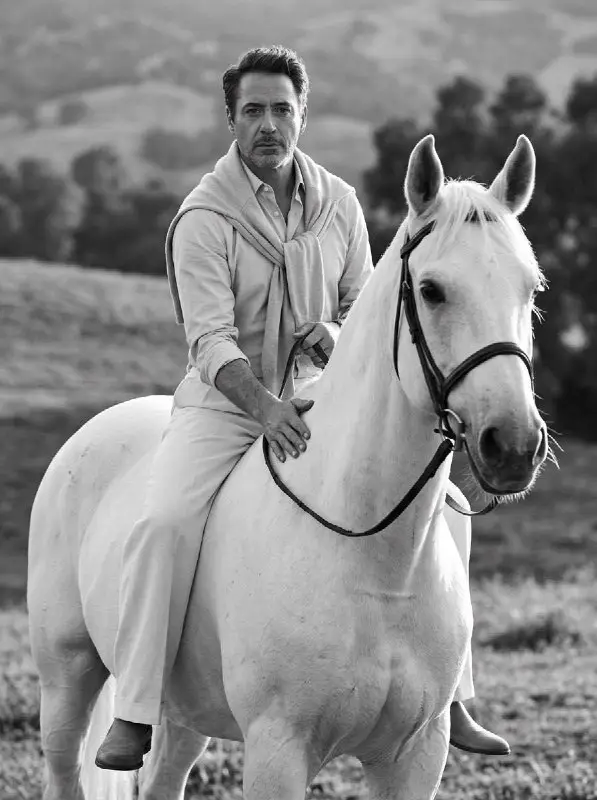 Mature man riding white horse in black and white portrait